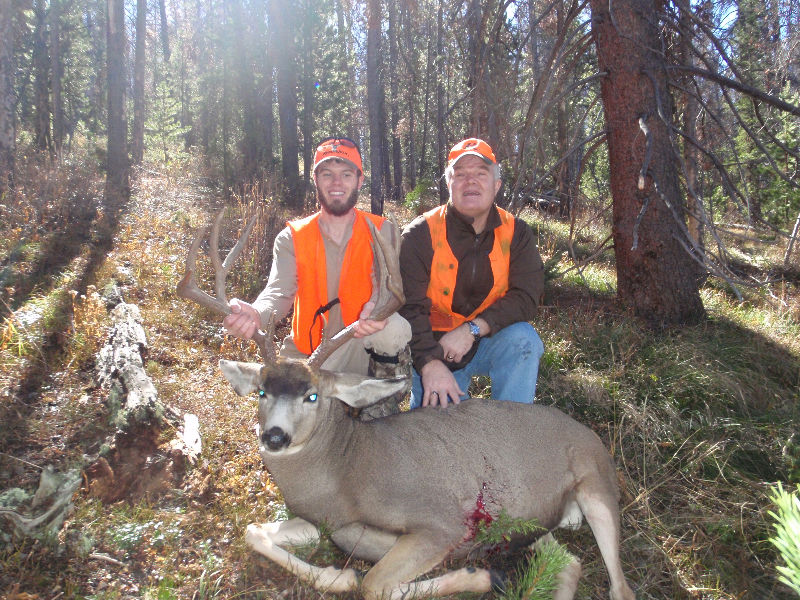 Hunters posing with trophy in fall 